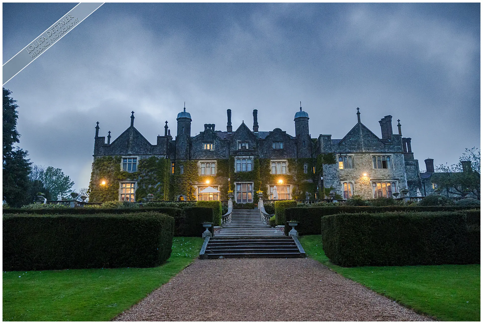 champneys eastwell manor, a large mansion with a walkway and bushes