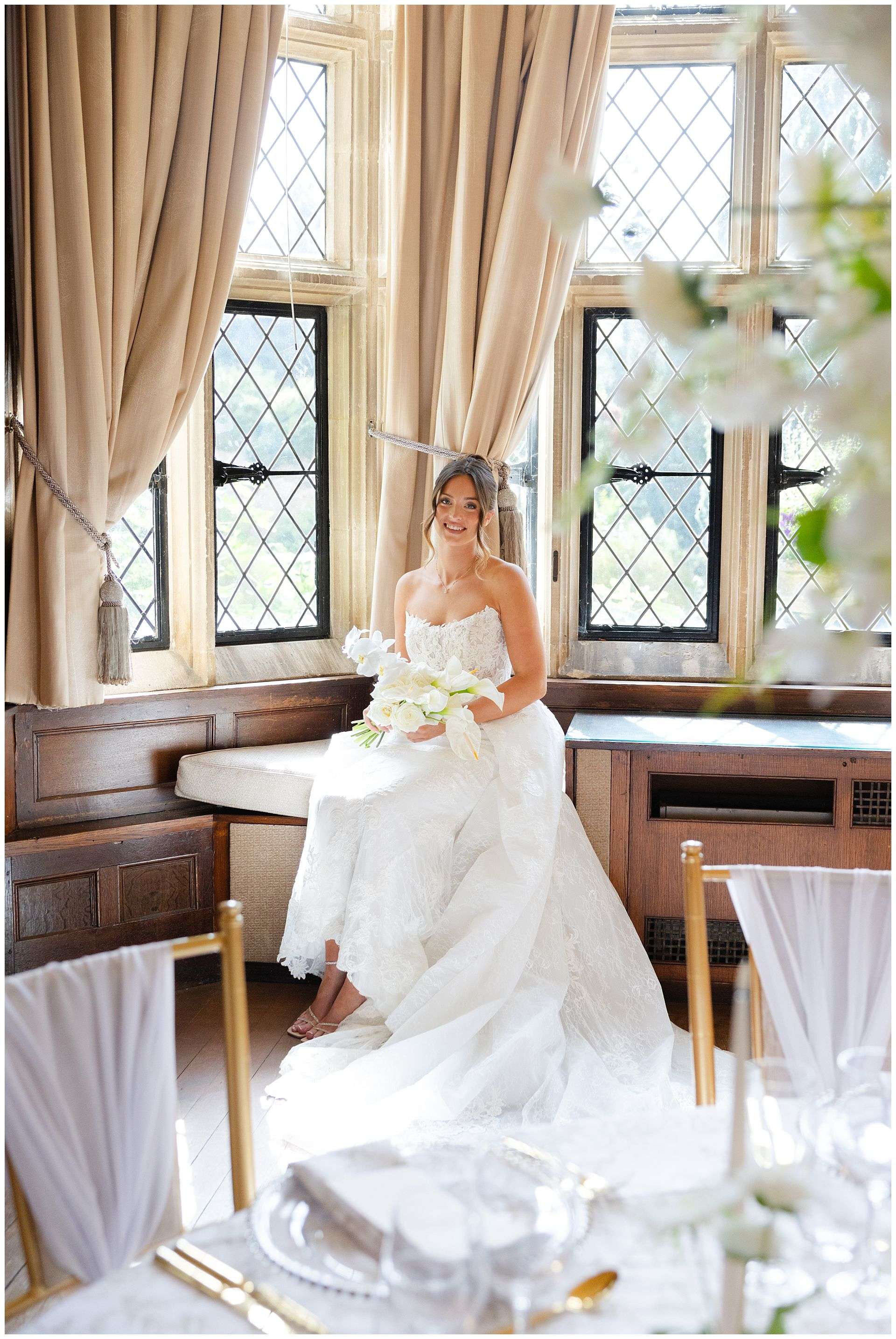 bride by sunlit windows eastwell manor photo shoot by louisa dettmer photography