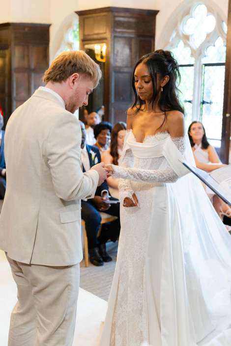 bride and groom exchange rings Bride and groom exchange rings during a wedding ceremony in a church.